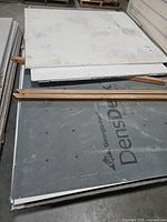 Stack of DensDeck branded sheet on top of other boards