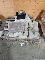 Pallet with concrete blocks and battery