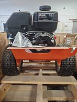 Front view showing Kohler SH Series 6.5 HP engine on orange Easy-Kleen frame with wheels