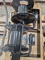 Top view of two steel hose reels with mounting arms visible