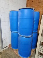 stack of blue plastic barrels on pallet