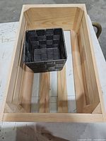 Wooden crate interior with woven basket placed inside