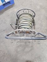 Top view of metal hose reel cart with coiled hose