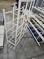 Single white tubular shelving unit standing upright