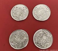 All four coins laid out showing Coat of Arms reverse