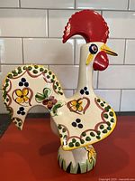 Full view of ceramic rooster figurine front and side