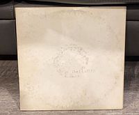 Front of gatefold sleeve showing embossed title and wear