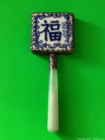 Full view of the mirror showing porcelain top and jade handle