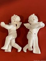 Both ceramic angel candle huggers front view