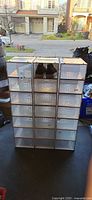 Front view of 21 stackable shoeboxes arranged 3×7