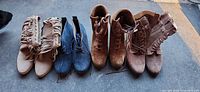 Four pairs of suede ankle boots front view