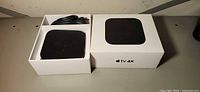 Apple TV 4K unit and box open showing contents