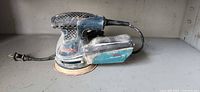 Left side view of Bosch GEX 125-1 AE sander showing entire tool and power cord