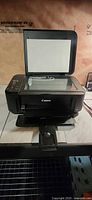 Canon Pixma MG2220 printer with lid open showing flatbed scanner