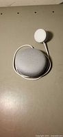 Top view of Google Nest Mini smart speaker in chalk color