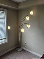 Lamp lit showing five illuminated shades and overall structure