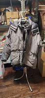 Front view of gray and black Mountain Equipment Co-op insulated hooded jacket on hanger