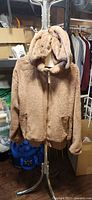 Front view of brown Tommy Hilfiger hooded fleece jacket on hanger