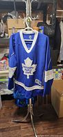 Full view of Toronto Maple Leafs jersey on hanger