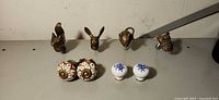 Overall view of four brass animal knobs and four ceramic knobs