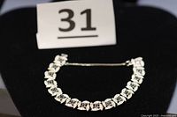 Full view of Panetta rhinestone bracelet on display stand