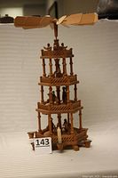 Full view of wooden 4-tier Christmas pyramid with rotor and candle holders