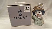 Front view of Lladro box beside figurine showing model and condition