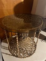 Full view of macrame side table with glass top