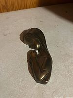 Front view of brass Virgin Mary wall hanging