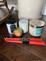 Group shot of all candles: two Bath & Body Works jar candles, Wick Witch tin, white jar candle, pair of red tapers