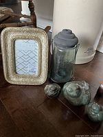 Group shot showing Mason jar lantern, ornate frame, three ceramic birds