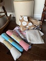 View of all fabric pieces including three rolled fleece fabrics and five assorted precut fabric squares