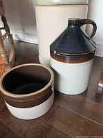 Stoneware jug and half crock on floor showing color and glazing details