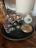 Overview showing wine glasses, Christmas glass, anniversary clock under dome, metal tray