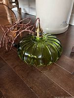 Overall view of green glass swag light showing ribbed shade and cord