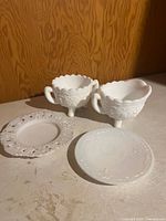 Overall view of two footed pieces and two small plates