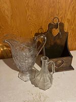 Group shot of pitcher, cruet and wooden holder