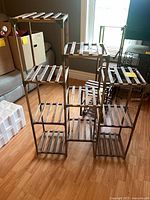 Full view of assembled modular wooden plant stand showing tiered shelves