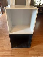 Front view showing white upper cube and black lower cube