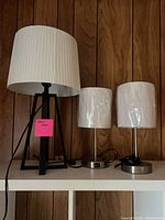 All three lamps on shelf showing size comparison