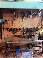 Wall display with C-clamps, spring clamps, quick-grip clamps, bungee cords and zip ties