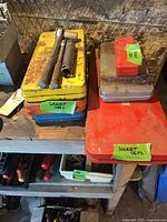 Stacked metal cases with two hand tools on top