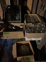 Cardboard boxes containing numerous clear glass canning jars with lids, assorted sizes