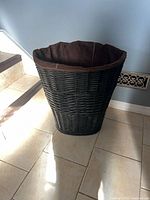 Full view of dark brown wicker hamper with liner