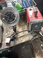 Radiant heater, hose with valve, and Honeywell heater on workbench