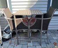 Full view of table and both chairs showing style, material and overall condition