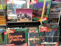 Group shot of five boxed light sculptures, mini box and nativity figures