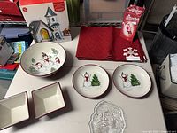 Entire lot on tabletop including bowls, placemats, stained-glass church box, glass Santa tray