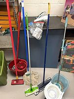 Group shot showing mops, bucket, tote and handheld vacuum