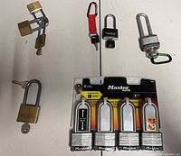 Overview showing all nine padlocks including packaged four-pack and loose locks